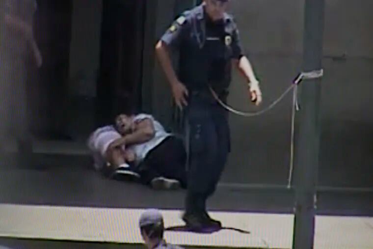 In this frame grab taken from a security camera provided by Campinas City Hall, two people shot by a gunman lie wounded at the entrance of the Metropolitan Cathedral, in Campinas, Brazil, Tuesday, Dec. 11, 2018. A man opened fire inside the cathedral in southern Brazil after Mass on Tuesday, killing four and leaving others injured before turning a gun on himself, authorities said. (Campinas City Hall via AP)