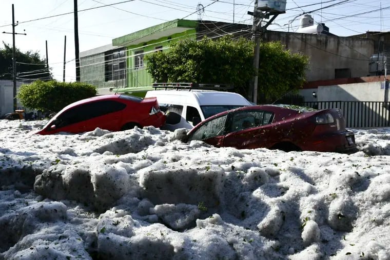 In this photo released by Jalisco State Civil Defense Agency, cars are suspended in hail in Guadalajara, Mexico, Sunday, June 30, 2019. Officials in Mexico's second largest city say a storm that dumped more than four feet of hail on parts of the metropolitan area damaged hundreds of homes. (Jalisco State Civil Defense Agency via AP)
