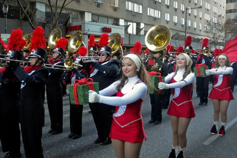 Members of the Southside marching band from Southside, Alabama, perform during the start of the Thanksgiving Day parade. ( RON TARVER / Staff Photographer )