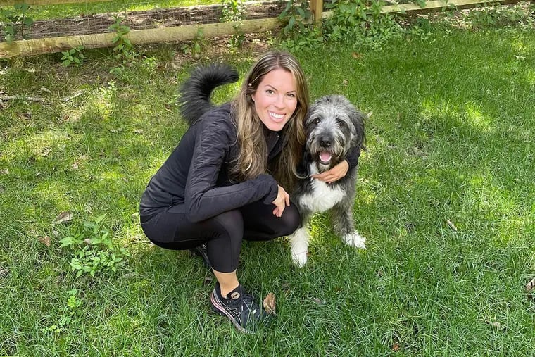Ashley poses with her dog, Auggie.