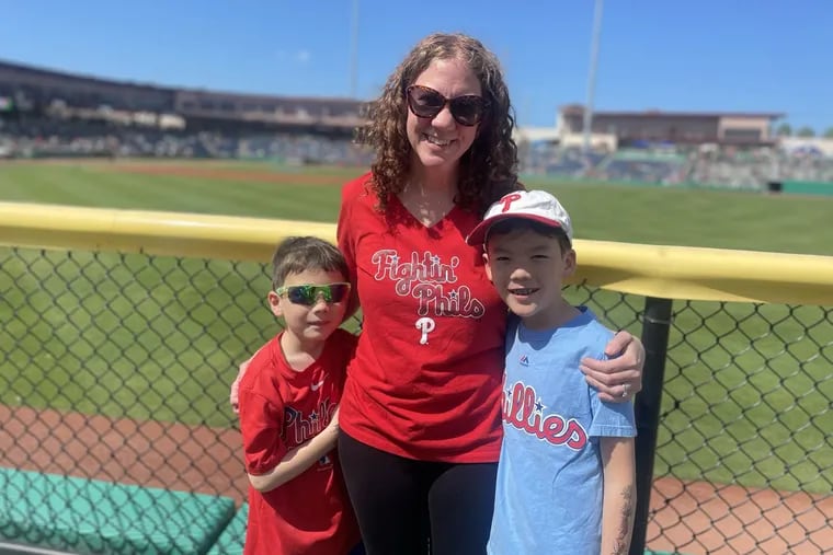 Inquirer reporter Kristen A. Graham with her sons, Julian, 7, and Kieran Goh, 9, at BayCare Ballpark in Clearwater, Fla.
