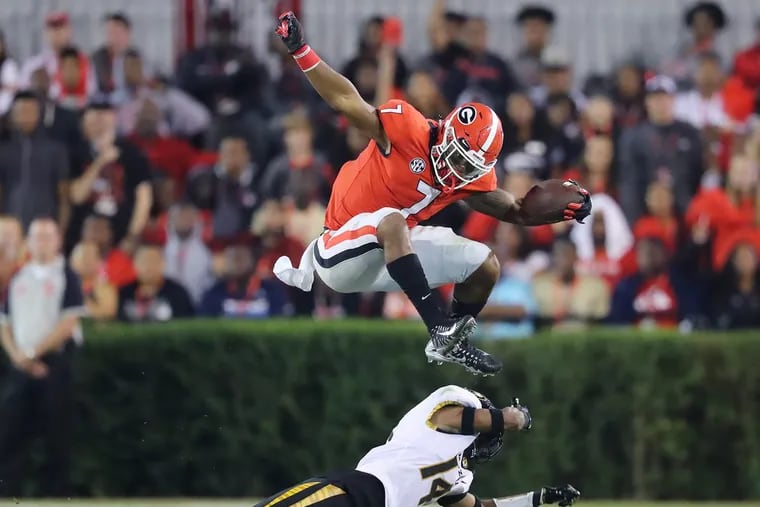 St. Joseph’s Prep grad D'Andre Swift, here leaping over a Missouri defender, and his Georgia teammates have a key game Saturday vs. Florida.