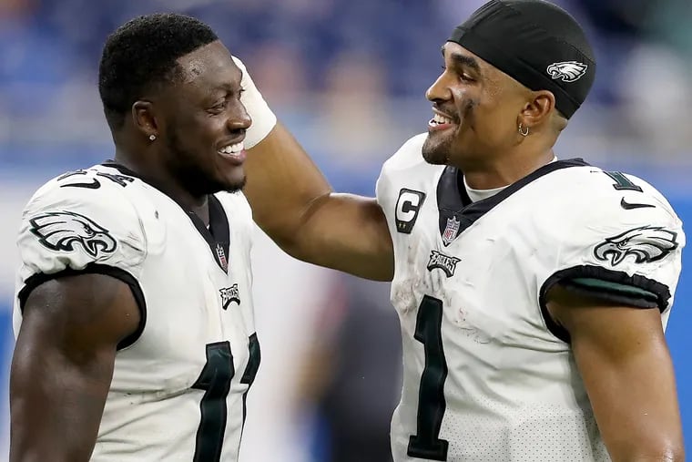 Eagles quarterback Jalen Hurts (right) celebrates with wide receiver A.J. Brown after the victory in Detroit.