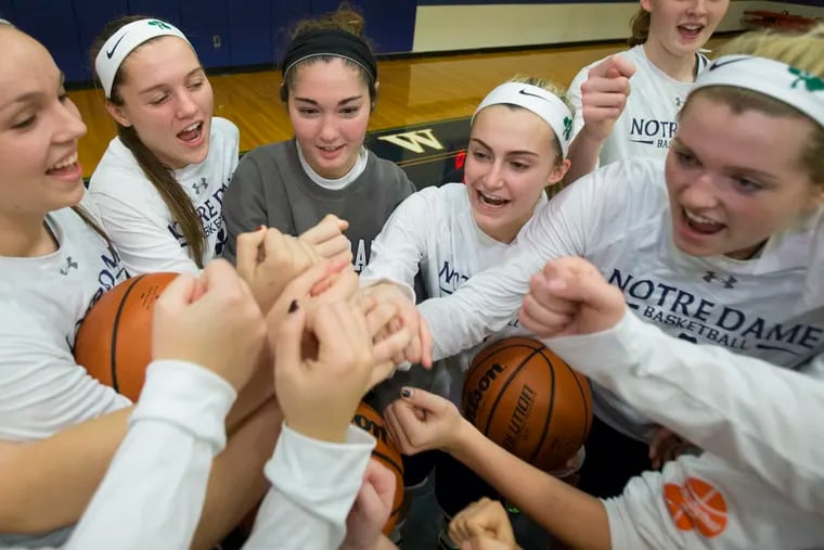 Notre Dame senior Leanne Purcell, center, has Wilson's disease and had a liver transplant. For a while they thought she wouldn't survive and had two surgeries following the transplant.  Now she is able to attend practice and sits on the bench at games. She huddles the Notre Dame team before their game at the Baldwin School on Dec. 17, 2015.   ( CHARLES FOX / Staff Photographer )