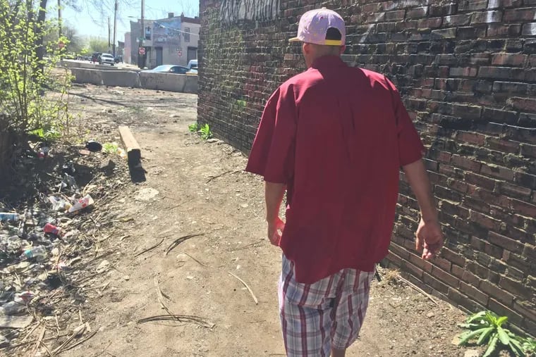 A man named Mike leaves the heroin encampment in Philly's Fairhill section on Tuesday. He comes daily, his says, to get high. He did not plan on watching the Dr. Oz show.