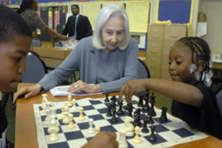 Marciene Mattleman watches India Squire make a move against Jarell Irving at Gideon Elementary. Mattleman's ASAP program helped the city school form a chess club.
