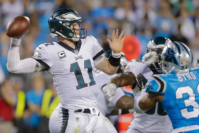 Philadelphia Eagles' Carson Wentz (11) aims a pass against the Carolina Panthers during the second half of an NFL football game in Charlotte, N.C., Thursday, Oct. 12, 2017. The Eagles won 28-23. (AP Photo/Bob Leverone)