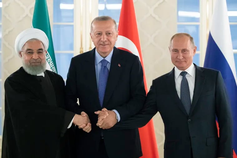 This Sept. 16, 2019 file photo, from left: Iranian President Hassan Rouhani, Turkish President Recep Tayyip Erdogan and Russian President Vladimir Putin shake hands during their meeting in Ankara, Turkey. America maintains some 1,000 troops in Syria who work alongside the Kurdish fighters. America’s foes -- Assad, Russia, and Iran -- all stand to gain from a U.S. troop withdrawal in Syria and will likely bide their time until they can move in and retake the area.