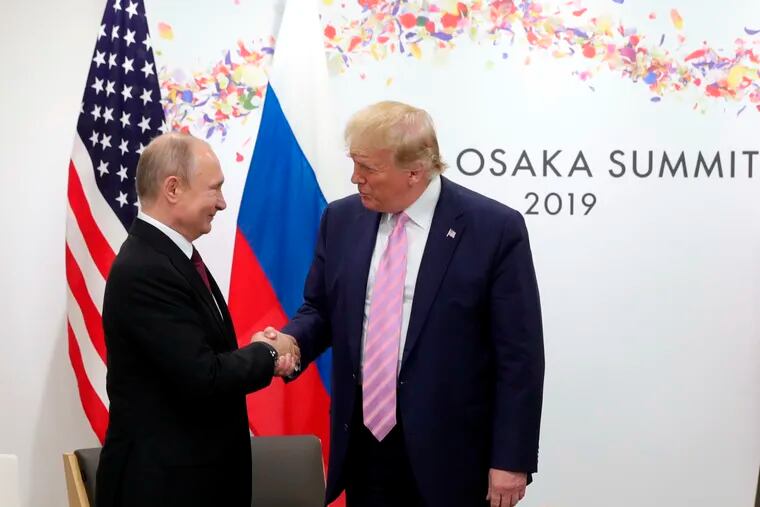 U.S. President Donald Trump, right, and Russian President Vladimir Putin greet each other during a bilateral meeting on the sidelines of the G-20 summit in Osaka, Japan, Friday, June 28, 2019.