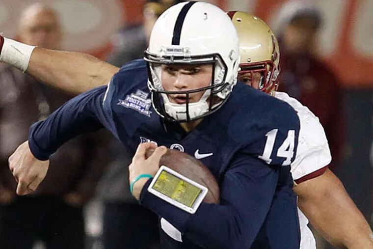 Quarterback Christian Hackenberg scrambles in the fourth quarter. Hackenberg threw four touchdown passes, including a 10-yarder to tight end Kyle Carter in overtime. (Ron Cortes/Staff Photographer)