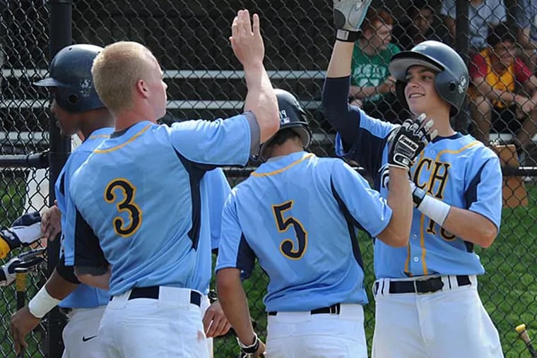 Springside Chestnut Hill Academy's Matt Caldwell gets high-fives after
scoring one of his team's seven runs in the first inning of the game they played against Penn Charter on Friday, May 10th.  (April Saul / Staff Photographer)