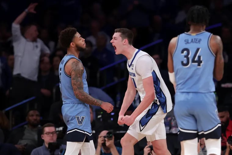 Ryan Kalkbrenner (2nd from left) of Creighton celebrates after scoring and drawing a foul during the 2nd half of their Big East Tournament game at Madison Square Garden on March 9, 2023. Justin Moore (left) and Brandon Slater of Villanova can only look on.