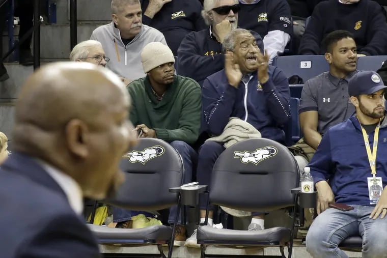 Mo Howard (right) claps for La Salle while his son, La Salle head coach Ashley Howard (in foreground on left) shouts instructions from the bench during the Lafayette vs. La Salle University mens basketball game at Tom Gola Arena in Phila., Pa. on November 10, 2018. La Salle lost a close one 77-76. ELIZABETH ROBERTSON / Staff Photographer