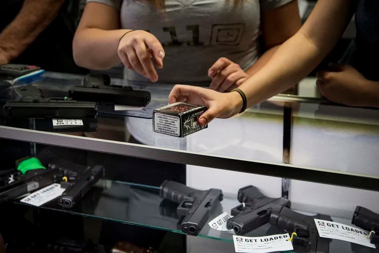 Store managers show a customer ammo at the Get Loaded gun store on June 30, 2016, in Grand Terrace, Calif. Changing the ammunition sold might be an effective route toward gun control, writes Ron Berler.