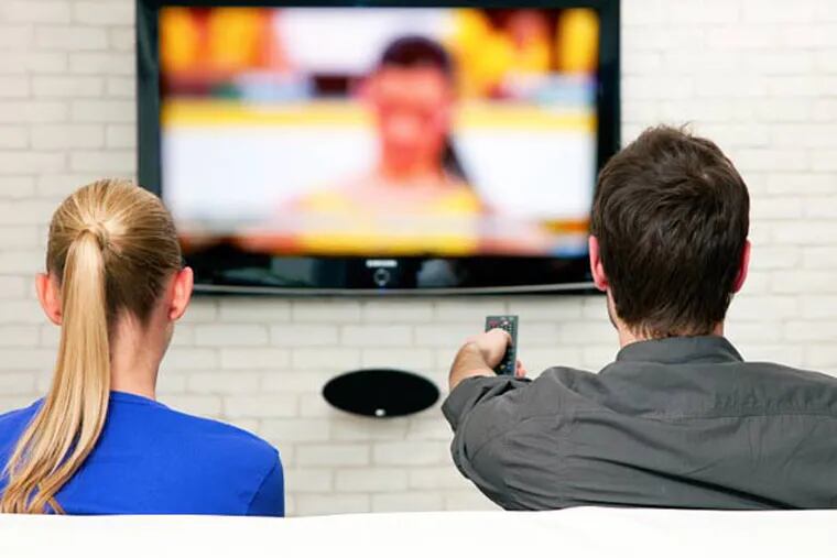 A couple watches television together. (iStock Photo)