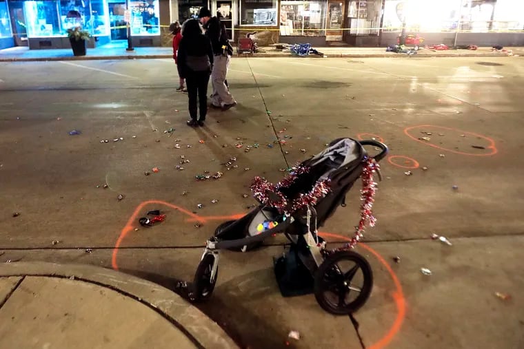 A broken children’s stroller lies in W. Main St. in downtown Waukesha after an SUV drove into Christmas parade-goers in gathered in the city Sunday, Nov. 21, 2021. (AP Photo/John Hart, Wisconsin State Journal)