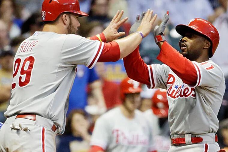 Jimmy Rollins is congratulated by teammate Cameron Rupp after hitting a two-run home run against the Brewers. (Morry Gash/AP)