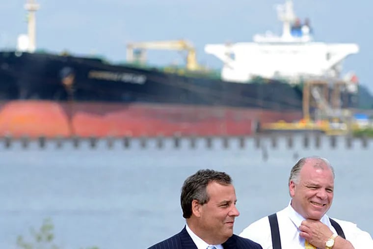 On the site of a former tank farm in Paulsboro Monday,  July 14, 2014, Gov. Christie (left) and Senate President Stephen Sweeney speak about the Holtec deal in Camden, which leads to a new marine terminal in Paulsboro finally being completed. TOM GRALISH / Staff Photographer