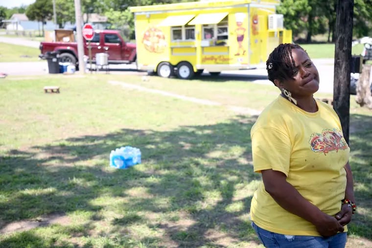 Kountry Queens food truck owner Tiffany Walton talking to media at the scene of a shooting at a Memorial Day event in Taft, Okla., on Sunday. Walton was working at her food truck when the incident happened.