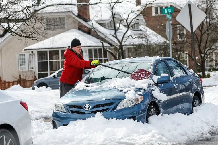 Bob Frees, 70, cleans off his car on after a snowfall in Phoenixville on Tuesday.