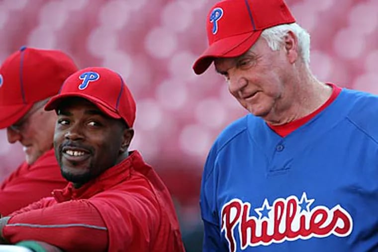 Jimmy Rollins (left), Charlie Manuel and the Phillies have been to four straight postseasons. (Yong Kim / Staff Photographer)