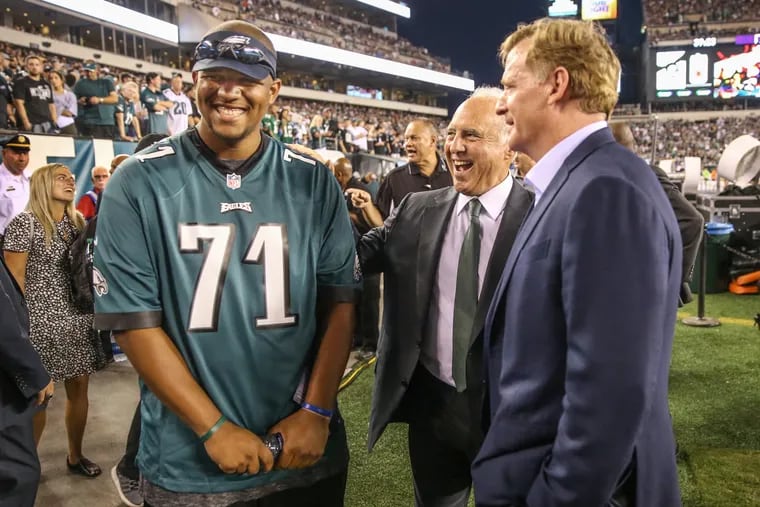 Ojay Harris, left, who will be at midfield at the coin toss of Thursday night's Eagles game, is all smiles as he talks with Eagles owner Jeffrey Lurie, center, and NFL Commisioner Roger Goodell, right, proir to the game against the Falcons at Lincoln Financial Field on September 6, 2018. MICHAEL BRYANT / Staff Photographer