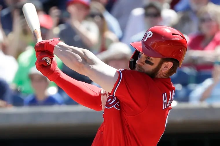 Bryce Harper swings at the first pitch he sees in his spring-training debut with the Phillies.