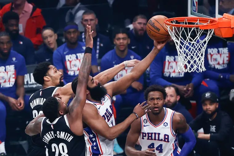 Sixers guard James Harden drives to the basket against Brooklyn Nets forward Dorian Finney-Smith and guard Spencer Dinwiddie during the first quarter of Game 4.