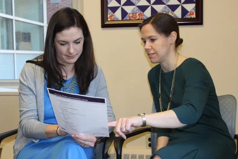 Jennifer Olenik, left, a palliative care physician, and Nina O'Connor, chief of the palliative care program at the University of Pennsylvania Health System, review paperwork for the Serious Illness Conversation project, a questionaire that helps doctors talk with patients about their priorities.