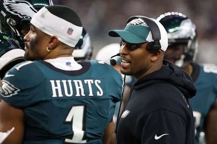 Eagles offensive coordinator Brian Johnson with Jalen Hurts during the loss to the Cowboys on Sunday.