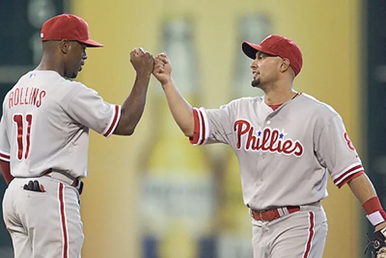 Jimmy Rollins and Shane Victorino celebrate the Phillies' 15-6 win in Houston Sunday afternoon. (Bob Levey/AP)