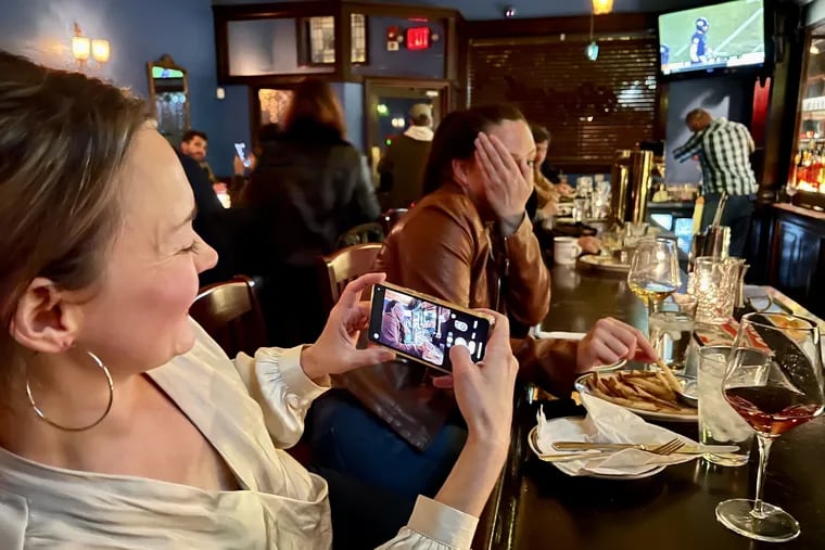 Ashley O'Neal tries to photograph her friend Leslie Hoff, who playfully rebuffs her, at Royal Tavern, 937 E. Passyunk Ave.
