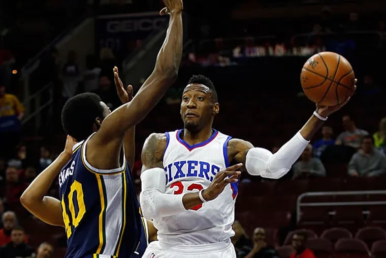 Sixers' Robert Covington passes the basketball against the Jazz Jeremy Evans. (Yong Kim/ Staff Photographer)
