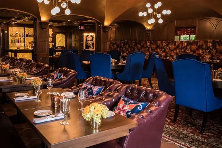 The blue velvet dining room chairs and pillow accents in Wayne's Autograph Brasserie happen to be the 2020 color of the year, Classic Blue.