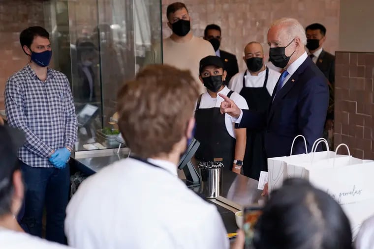 President Joe Biden talks with employees during a visit to Taqueria Las Gemelas restaurant Wednesday.