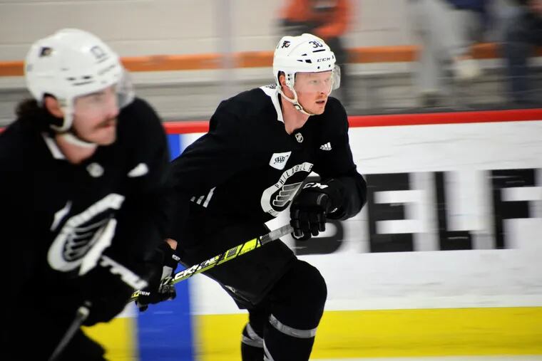 Patrick Brown, right, participates in Flyers practice on Friday, Feb. 18, 2022. Brown had been out with an MCL injury.