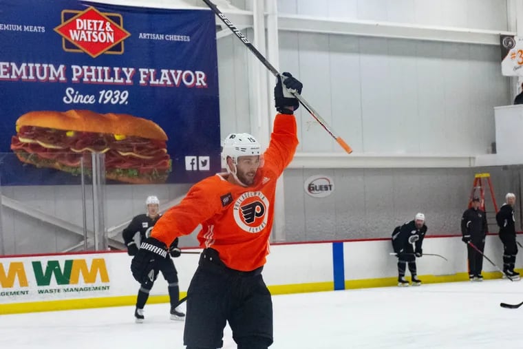Center Derrick Brassard celebrates after assisting right wing Cam Atkinson's goal during Flyers training camp on Sunday, Sept. 26, 2021 in Vorhees, NJ.