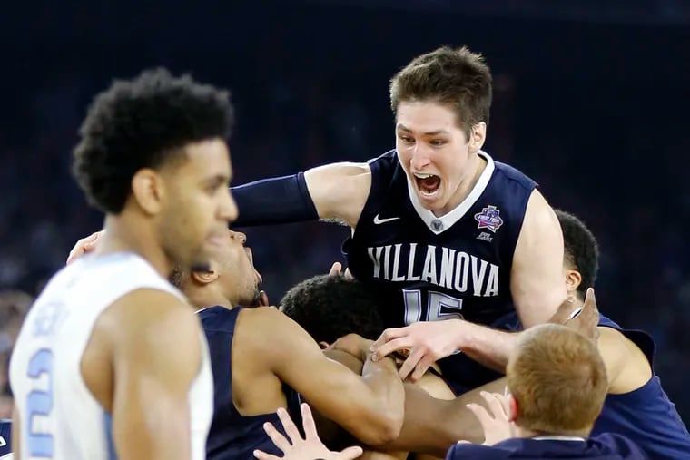 Villanova's Ryan Arcidiacono (top, right) and teammates celebrate Kris Jenkins' game-winner in 2016 NCAA title game. They missed out on making money as college players.