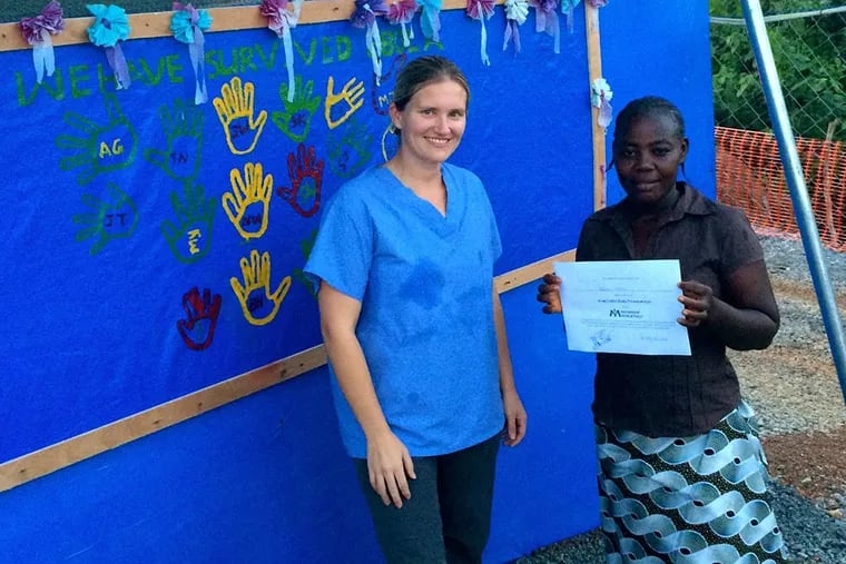 The University of Pennsylvania’s Trish Henwood outside an Ebola treatment center in Liberia with Hawa, who survived the disease. (Photo courtesy of Trish Henwood)