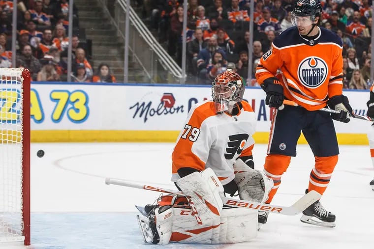 The Flyers' Carter Hart and Edmonton's' James Neal (18) watch the puck go into the net during the host Oilers' 6-3 win Wednesday, ruining the goalie's homecoming.