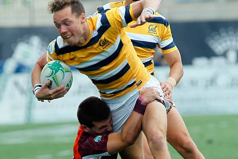 University of California's Harry Adolphus, tries to break the
grasp of  Virginia Tech's Adam D'Amico in the first half of their
match in the Penn Mutual Collegiate Rugby Championships, Saturday, May 30, 2015, in Chester, PA. Cal won the match 12-7. (Tom Mihalek/For the Inquirer)