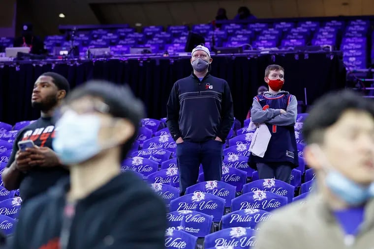 Masked Sixers fans watched pregame warm-ups before the Sixers' Monday playoff game against the Toronto Raptors, during Philadelphia's short-lived revival of an indoor mask mandate.