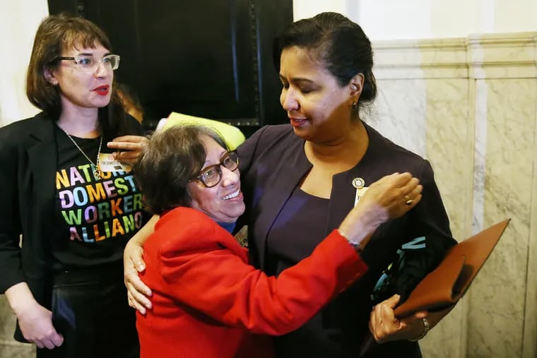 Mercedes Reyes (center), a live-in domestic worker and leader within the Pennsylvania Domestic Workers Alliance, hugs then-City Councilmember Maria Quiñones Sánchez (right) after City Council passed a bill expanding labor protections for domestic worker in 2019.