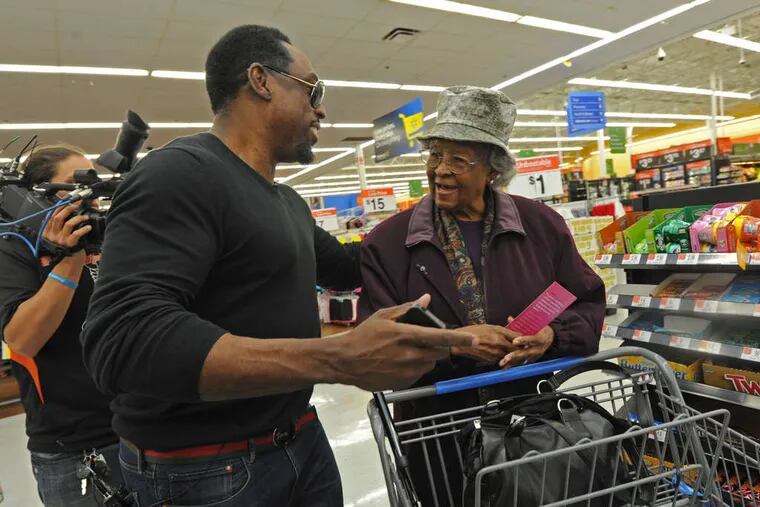 Keven Parker, whose Spread the Love Foundation helps others, surprises Geneva Dawson at a Wal-Mart with the news that he'll pay for what's in her shopping cart.