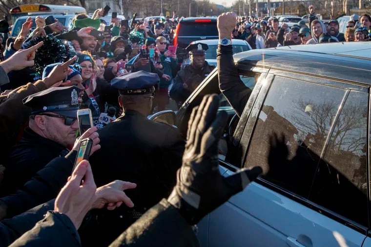 Eagles head coach Doug Pederson gives the fans a cheer as he drives away from the NovaCare Complex Monday, February 5, 2018 after the team's arrival back in Philadelphia a day after defeating the New England Patriots in Super Bowl LII.