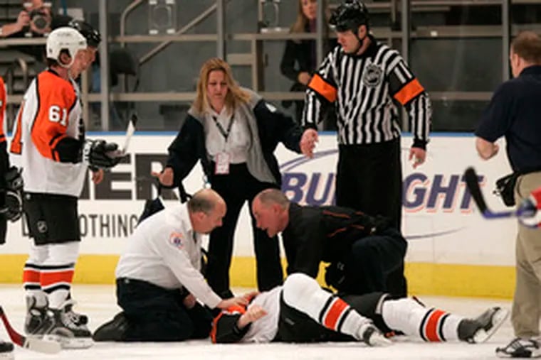 Medical personnel attend to the Flyers&#0039; Todd Fedoruk after he was knocked out in a fight with the Rangers&#0039; Colton Orr. He was hospitalized overnight in New York for observation.