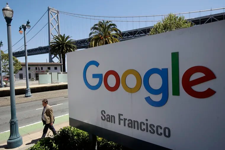 A man walks past a Google sign in San Francisco on May 1, 2019. Attorneys general of 48 U.S. states, the District of Columbia, and Puerto Rico announced an antitrust investigation into Google parent company Alphabet Inc. on Monday, Sept. 9, to determine if the company has become too big.