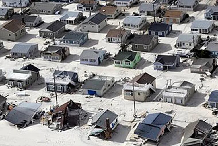 Sand fills the streets in the wake of superstorm Sandy, along the central Jersey Shore, N.J. (AP Photo/Mike Groll)