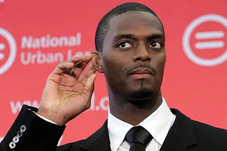 As Michael Vick did when he got out of prison, Plaxico Burress has turned to Tony Dungy for mentoring. (Richard Drew/AP)