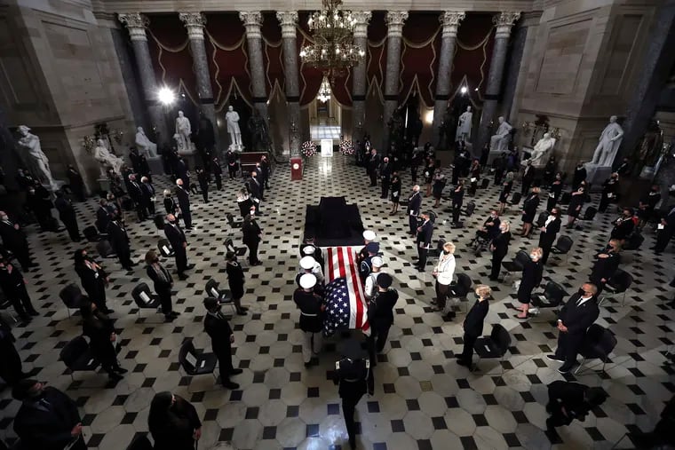 The flag-draped casket of Justice Ruth Bader Ginsburg is carried in to Statuary Hall where Ginsburg will lie in state Friday, Sept. 25, 2020, in Washington.